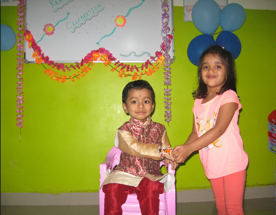 Kids tying rakhi and celebrating Raksha Bandhan at preschool